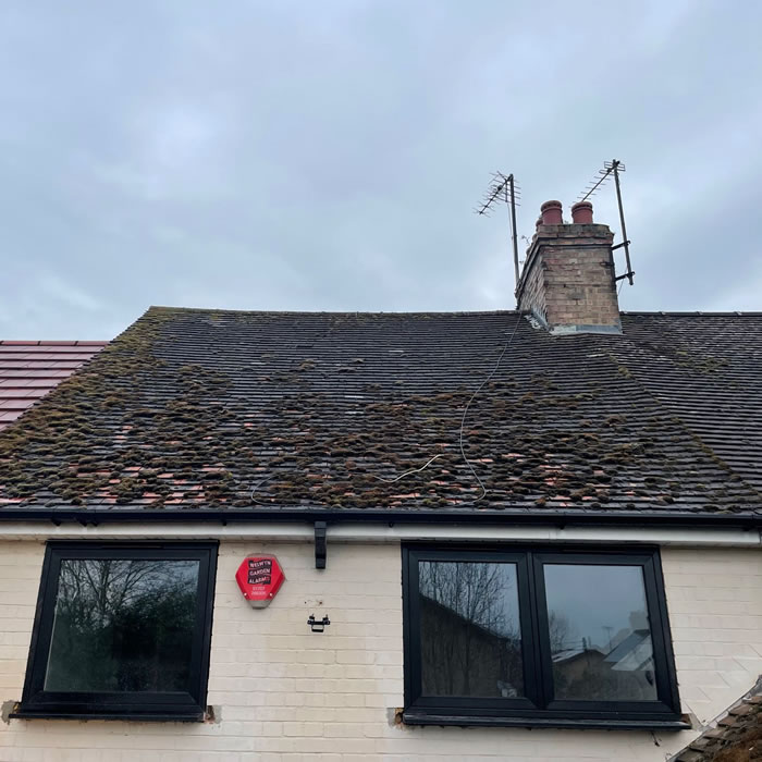 Roof covered in moss, lichen, debris and algae before roof clean